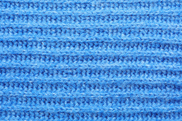 Blue winter sweater as background, closeup view