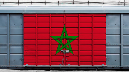 Front view of a container train freight car with a large metal lock with the national flag of Morocco.The concept of export-import,transportation, national delivery of goods and rail transportation