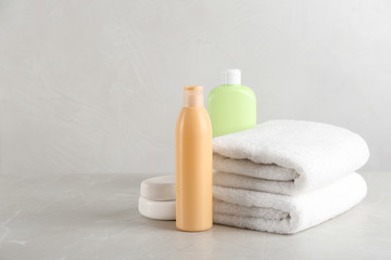 Plakat Fresh towels and toiletries on light grey marble table. Space for text