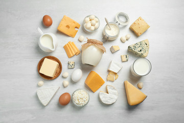 Different delicious dairy products on white table, flat lay