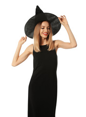 Fototapeta premium Beautiful young woman wearing witch costume for Halloween party on white background