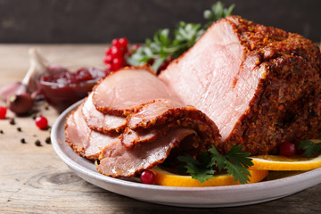 Delicious ham served with garnish on wooden table, closeup