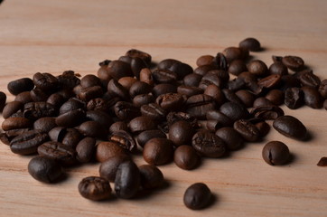 Coffee beans and traditional cup on wood table