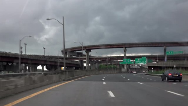 Driving on a highway during a rainstorm.