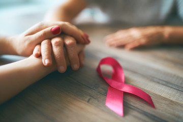 Females hands and symbol of Breast Cancer Awareness