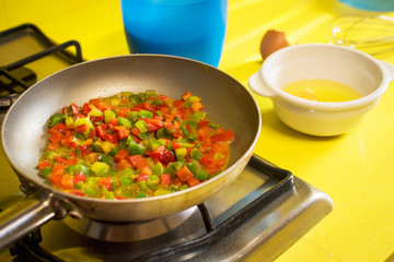Cooking food in a kitchen with yellow marble.