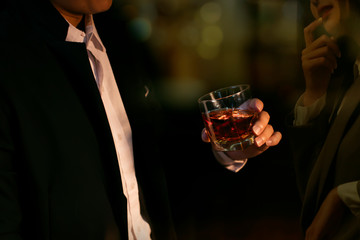 Closeup businessmen holding a glass of whiskey