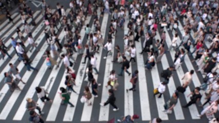 UMEDA, OSAKA, JAPAN - CIRCA SEPTEMBER 2019 : Aerial blurred view of zebra crossing near Osaka train station. Crowd of people at the street. Shot in busy rush hour. Slow motion.