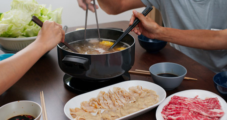 Family having hot pot together at home
