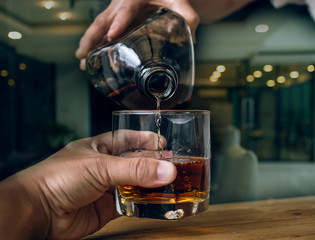 Bartender Serve Whiskey, on wood bar 