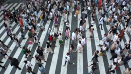 UMEDA, OSAKA, JAPAN - CIRCA SEPTEMBER 2019 : Aerial blurred view of zebra crossing near Osaka train station. Crowd of people at the street. Shot in busy rush hour. Slow motion.