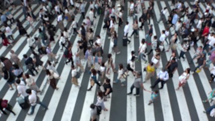 UMEDA, OSAKA, JAPAN - CIRCA SEPTEMBER 2019 : Aerial blurred view of zebra crossing near Osaka train station. Crowd of people at the street. Shot in busy rush hour. Slow motion.
