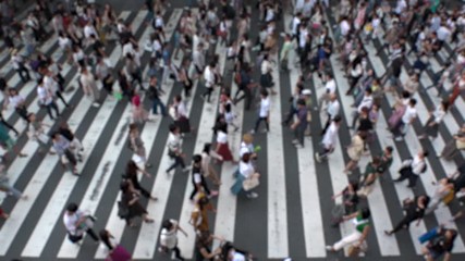 UMEDA, OSAKA, JAPAN - CIRCA SEPTEMBER 2019 : Aerial blurred view of zebra crossing near Osaka train station. Crowd of people at the street. Shot in busy rush hour. Slow motion.