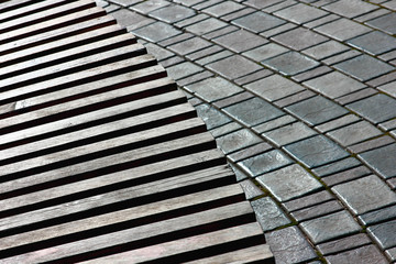 relief structure of a wooden bench in combination with decorative paving stones