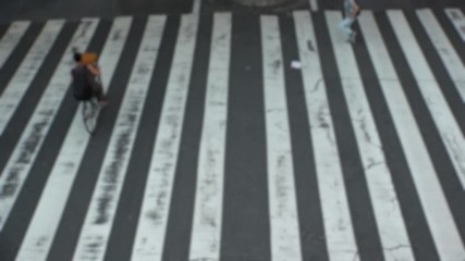 UMEDA, OSAKA, JAPAN - CIRCA SEPTEMBER 2019 : Aerial blurred view of zebra crossing near Osaka train station. Crowd of people at the street. Shot in busy rush hour. Slow motion.
