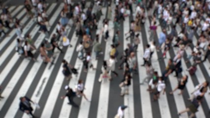 UMEDA, OSAKA, JAPAN - CIRCA SEPTEMBER 2019 : Aerial blurred view of zebra crossing near Osaka train station. Crowd of people at the street. Shot in busy rush hour. Slow motion.