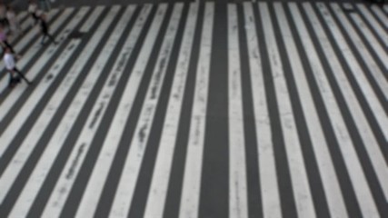 UMEDA, OSAKA, JAPAN - CIRCA SEPTEMBER 2019 : Aerial blurred view of zebra crossing near Osaka train station. Crowd of people at the street. Shot in busy rush hour. Slow motion.