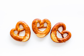 Octoberfest symbol. Fresh bavarian pretzels on white background top view copy space
