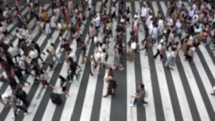 UMEDA, OSAKA, JAPAN - CIRCA SEPTEMBER 2019 : Aerial blurred view of zebra crossing near Osaka train station. Crowd of people at the street. Shot in busy rush hour. Slow motion.