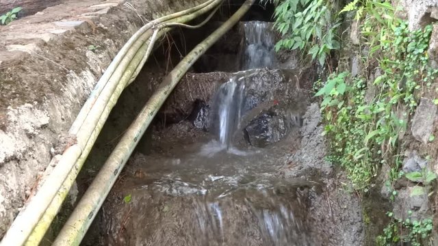 small river that flows from the height of the hill. a lot of paralon pipes on the edge, that's a clean water pipe from a mountain spring