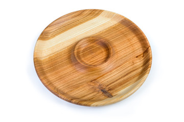 Empty round wooden serving dish with sauce boat in center