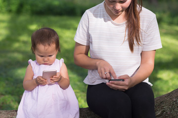 Parent and child on their phones.