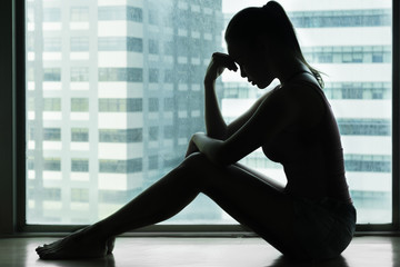 Depressed stressed woman alone in the city. 