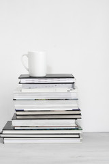 Fototapeta na wymiar Cup of coffee on stack of books