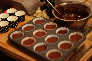 the process of preparing cupcakes - before sending to bake, close up