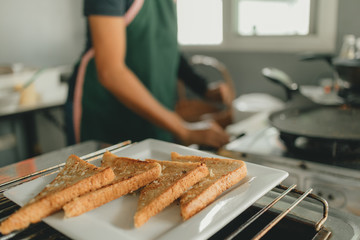 Sliced Garlic breads served on white dish.