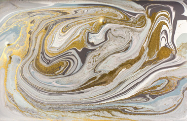 Gray marble pattern with golden glitter. Stone ripple texture.