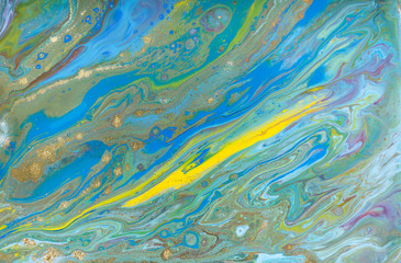 Blue and yellow marble pattern with golden glitter. Abstract liquid background