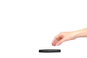 Hand with black mascara, eye makeup brush.