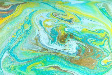 Blue and yellow marble pattern with golden glitter. Abstract liquid background