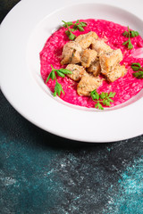 risotto chicken meat (red rice with beetroot flavor, delicious main course) menu concept. food background. copy space. Top view