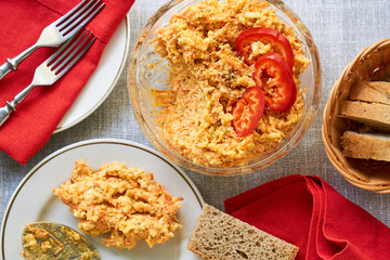 Rice salad with carrots and cheese in a glass bowl