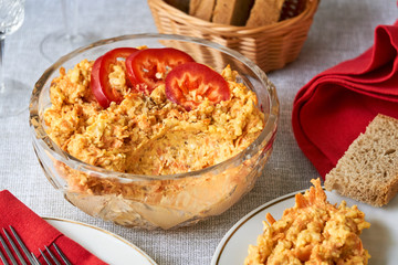 Rice salad with carrots and cheese in a glass bowl