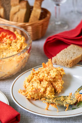 Rice salad with carrots and cheese on a white plate  