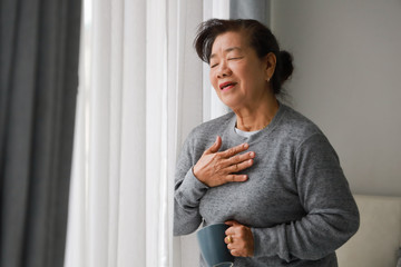 Asian senior woman mother sick with heart attact in living room