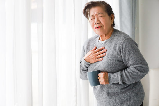 Asian senior woman mother sick with heart attact in living room