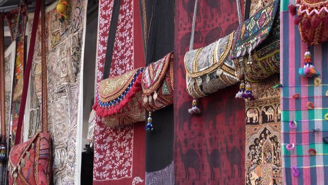 Patchwork carpets and homemade bags for sell in local street market, Udaipur, Rajasthan, India. Close up