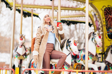 Outdoor photo of happy girl in amusement park in winter