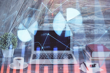 Double exposure of graph and financial info and work space with computer background. Concept of...