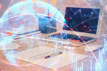 Financial chart drawing and table with computer on background. Multi exposure. Concept of international markets.