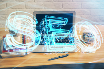Multi exposure of table with computer and seo drawing hologram. Search optimization concept.
