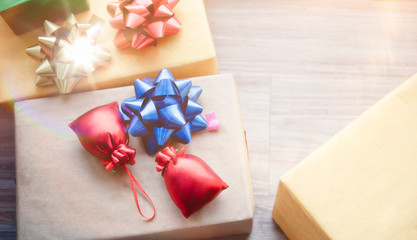 Three Christmas boxes with decoration gift on a floor with glow light. Happy new year and merry x-mas.