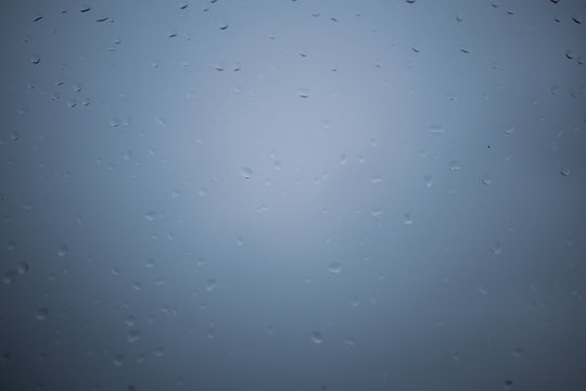 Raindrops on window with background