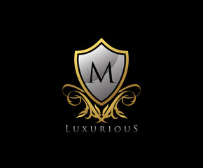 Classy Shield Letter M Gold Letter Logo Icon.