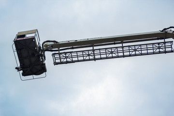 telescopic lift of fire truck on sky background