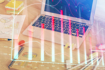 Financial market graph hologram and personal computer on background. Double exposure. Concept of...